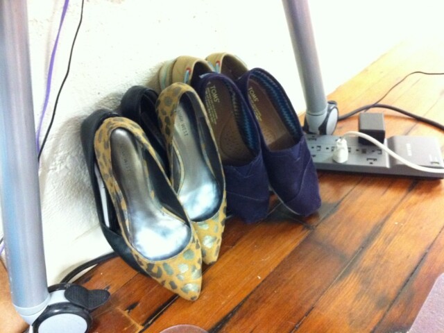 Shoe pile under desk at work