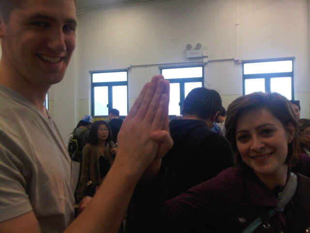 Chris and Lindsay do the secret Michigan high five in the ferry line on Lamma Island