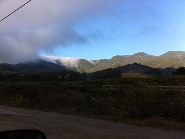 Clouds hugging mtn top. Looks like snow.